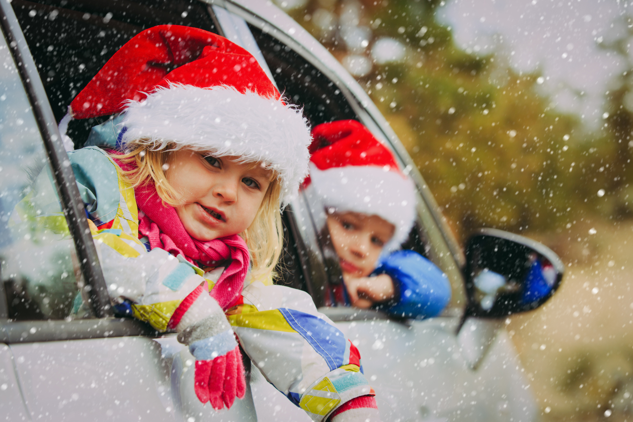 Christmas car travel- happy kids travel in winter nature