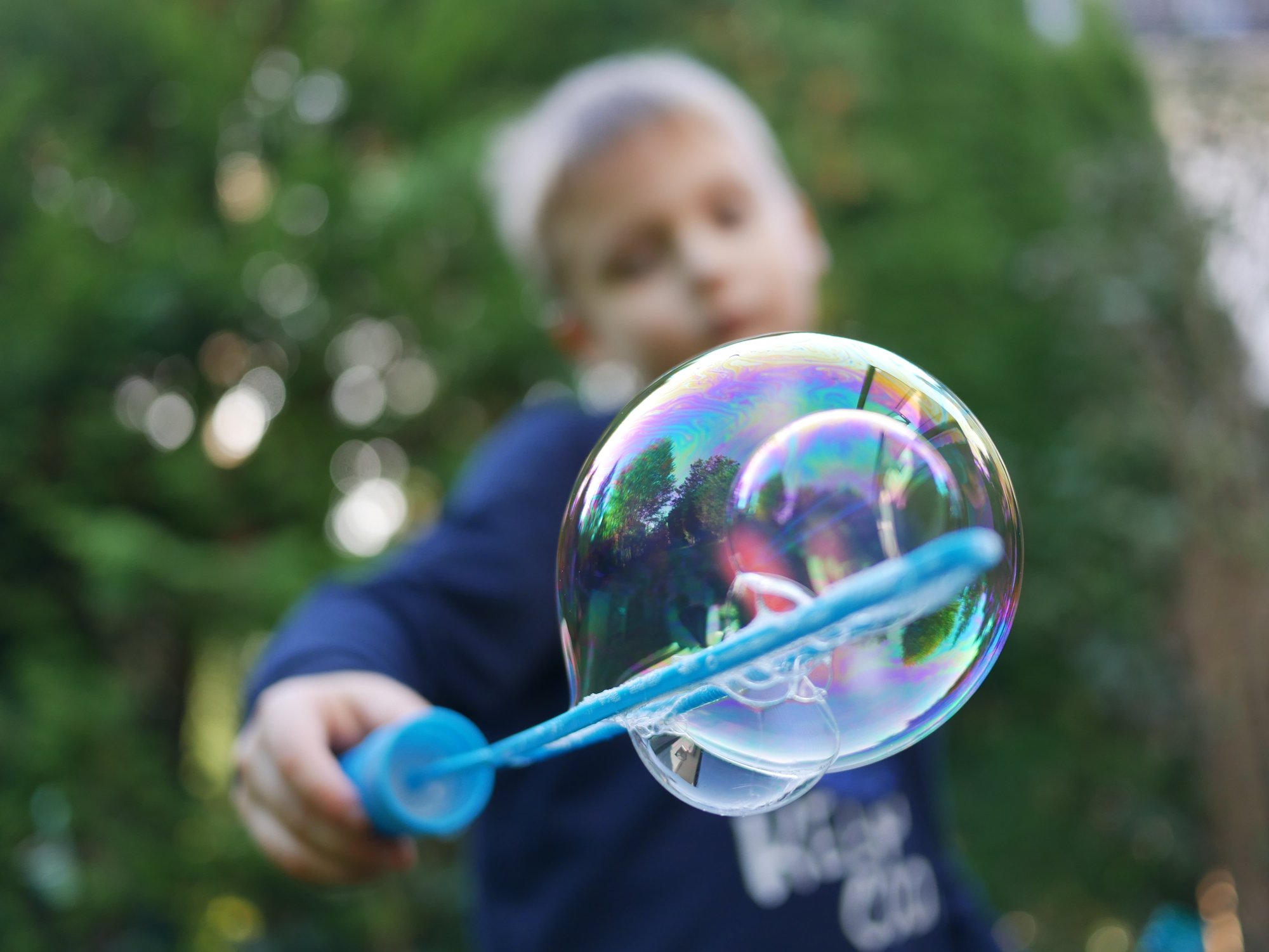 Young boy using a bubble wand