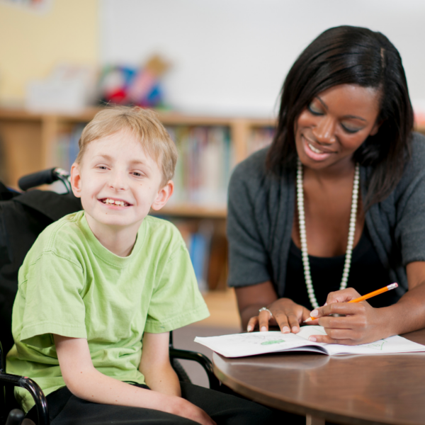 woman teaching child in a wheelchair